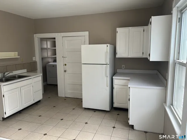 a utility room with cabinets washer and dryer