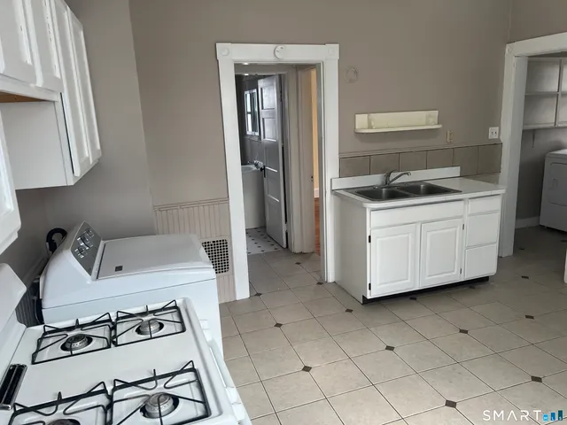 a kitchen with a sink cabinets and stainless steel appliances
