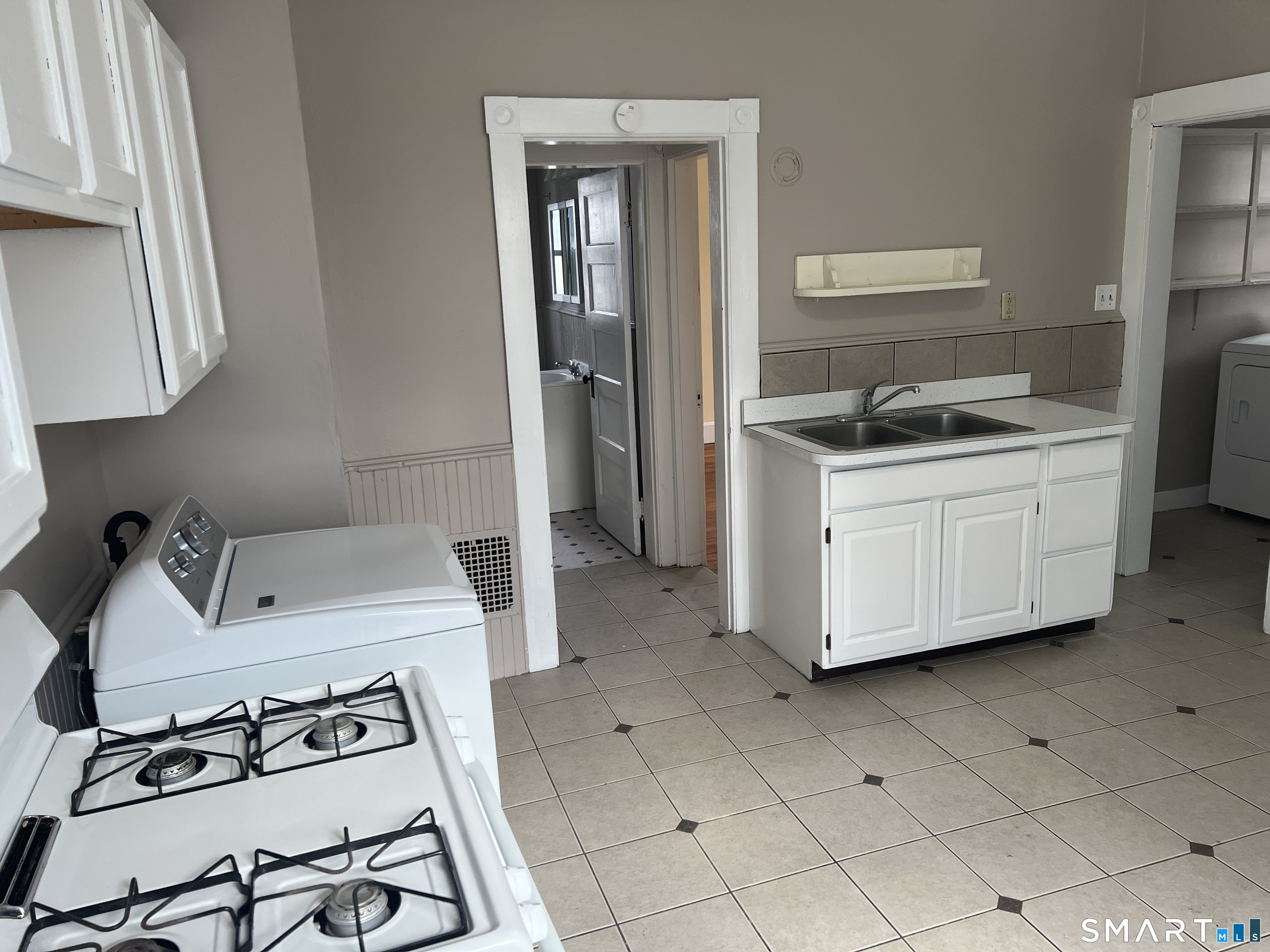40 Prospect Street Ansonia, CT 06401 - Photo 18 of 31 a kitchen with a sink cabinets and stainless steel appliances
