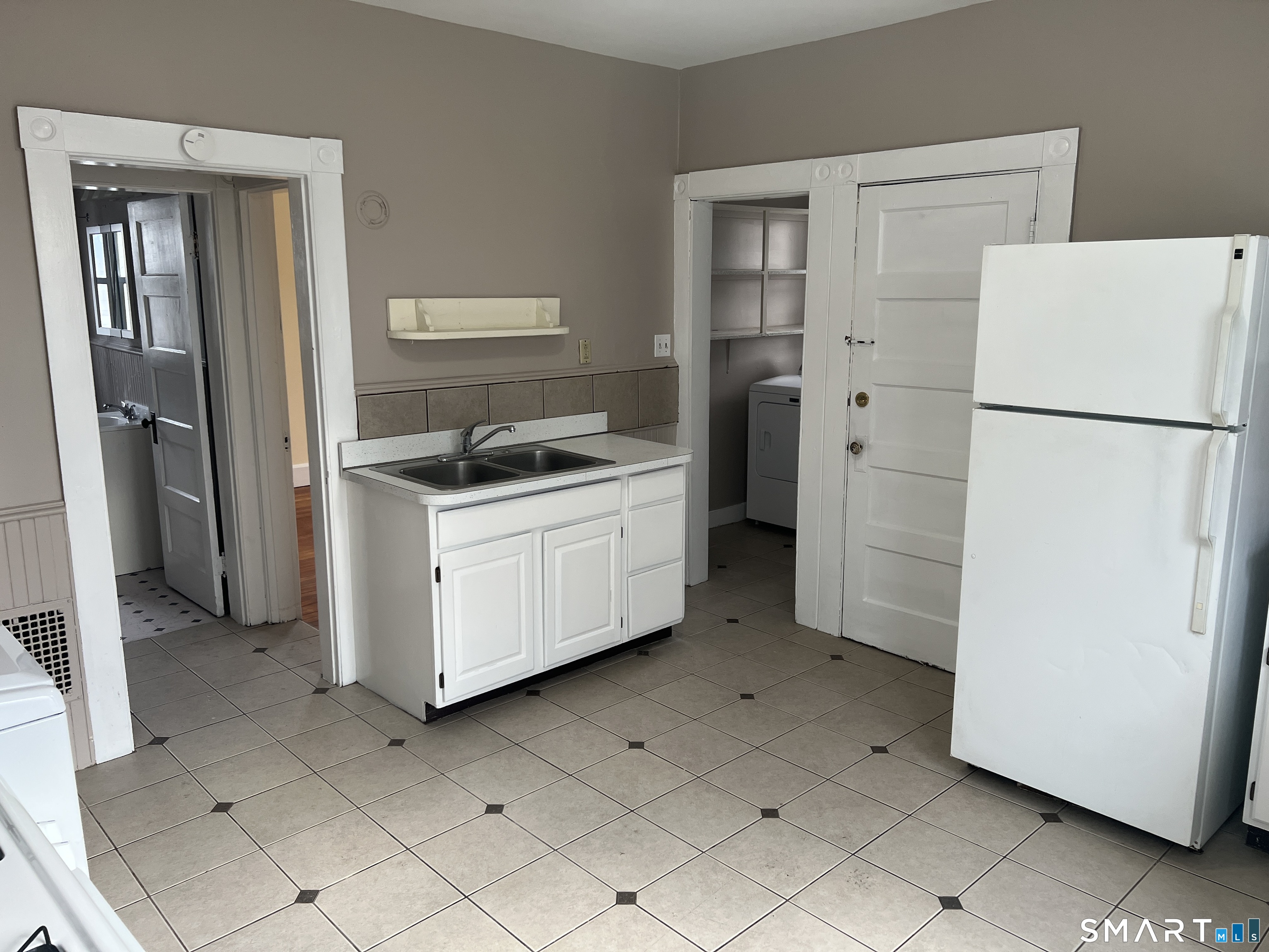 40 Prospect Street Ansonia, CT 06401 - Photo 19 of 31 a kitchen with a refrigerator sink stove and cabinets