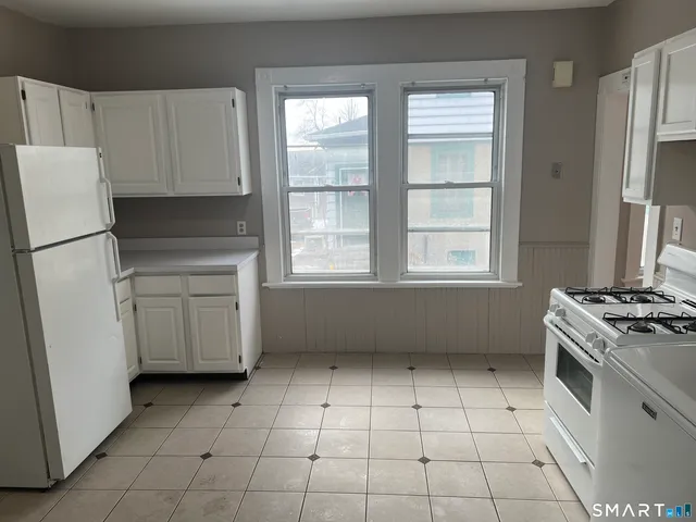a kitchen with a stove a refrigerator and a sink