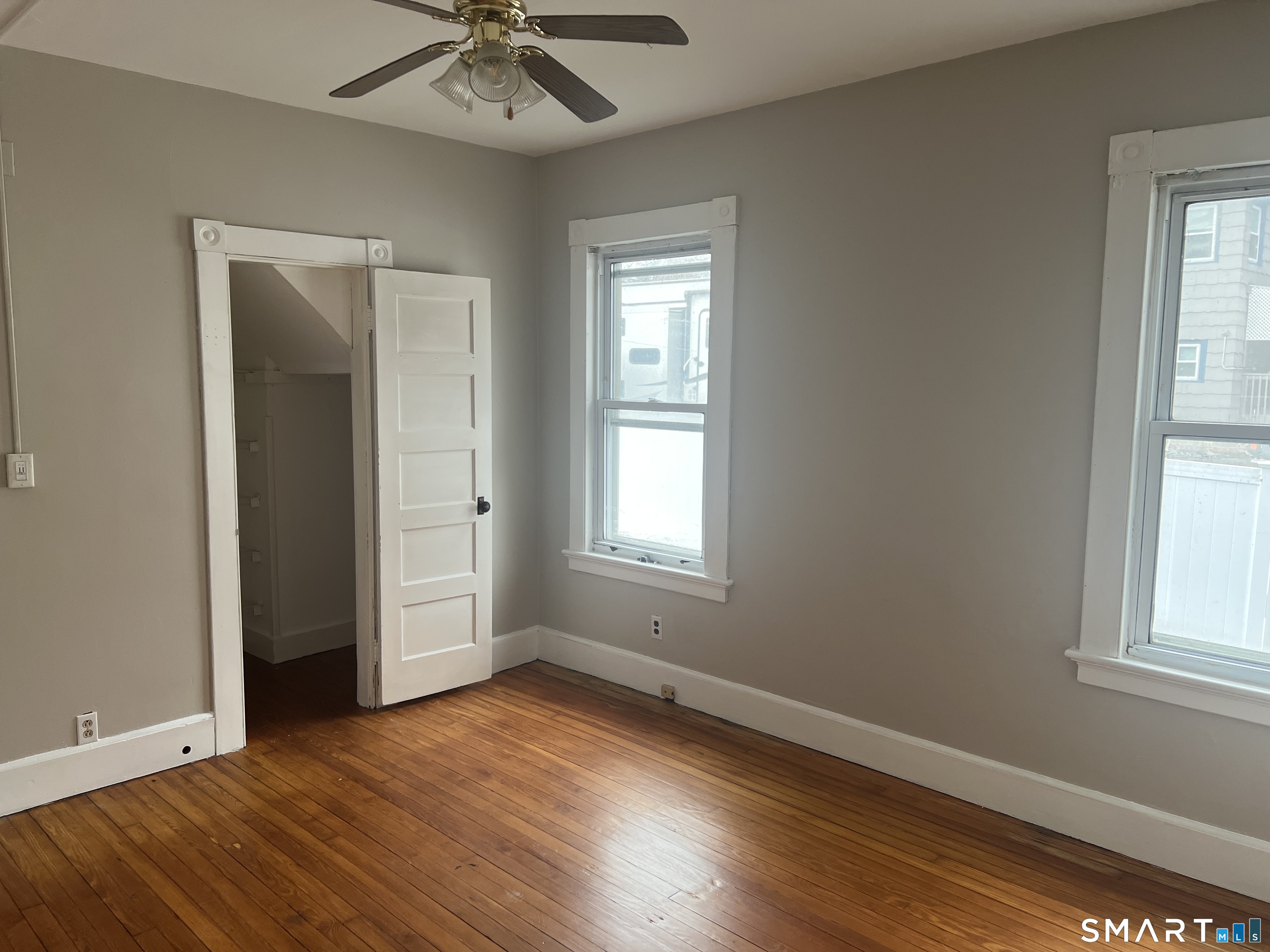 40 Prospect Street Ansonia, CT 06401 - Photo 29 of 31 an empty room with wooden floor and windows