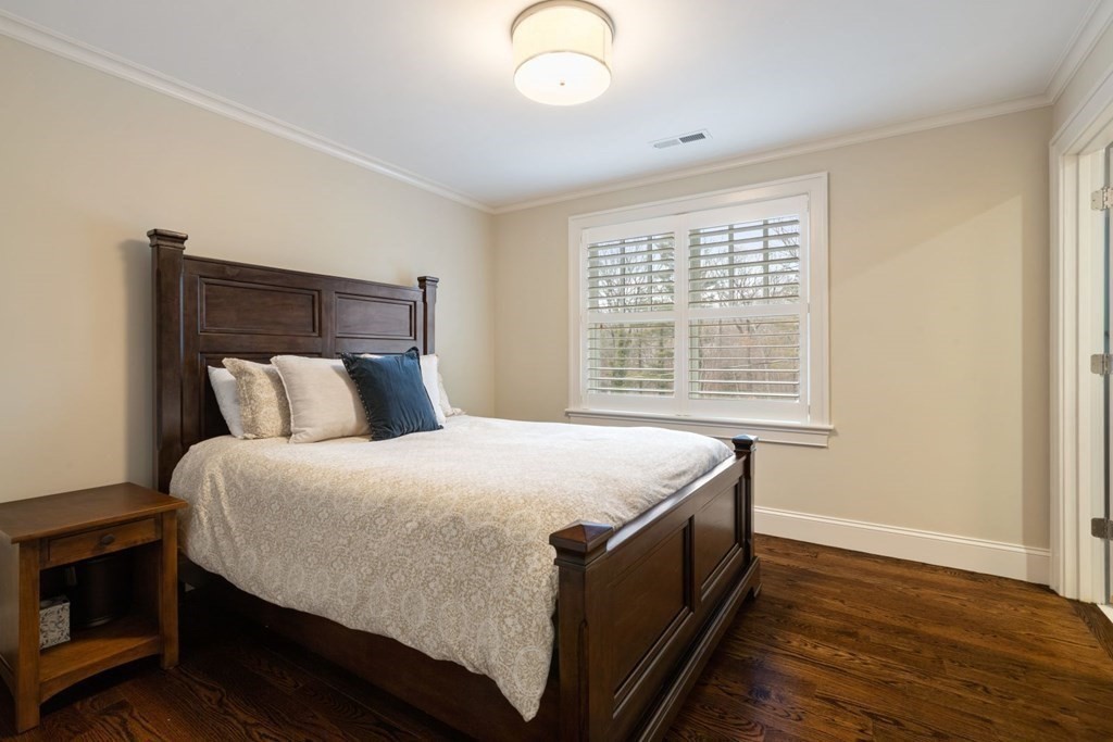 48 MacArthur Road Wellesley, MA 02482 - Photo 17 of 26 a bed sitting in a bedroom next to a window