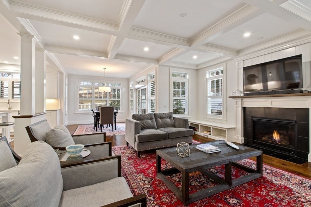 48 MacArthur Road Wellesley, MA 02482 - Photo 8 of 26 a living room with furniture a flat screen tv and a fireplace