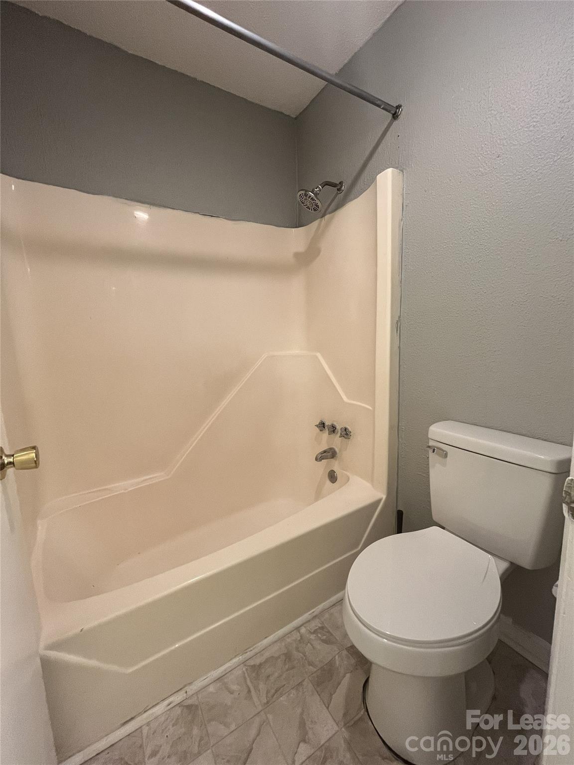 1911 Smoke Ridge Court, Unit 5 Charlotte, NC 28210 - Photo 15 of 16 a white toilet sitting next to a bath tub and a shower