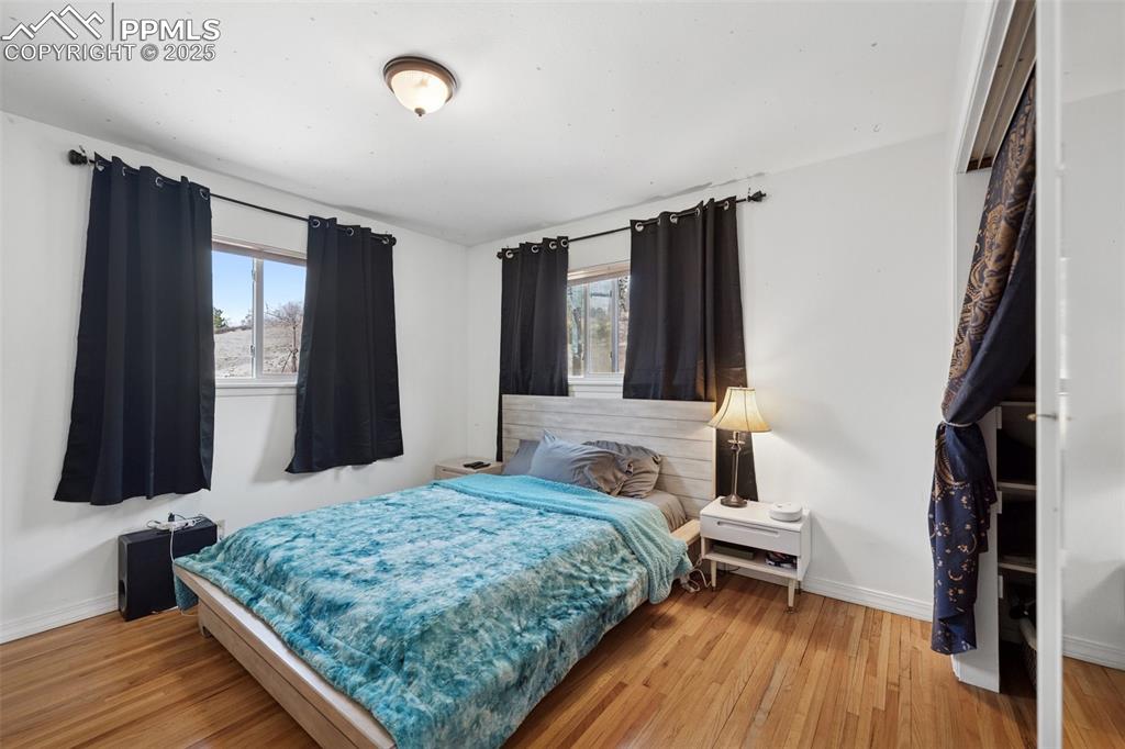 985 Fuller Road Colorado Springs, CO 80920 - Photo 13 of 30 a bedroom with a bed and a flat tv screen on a dresser