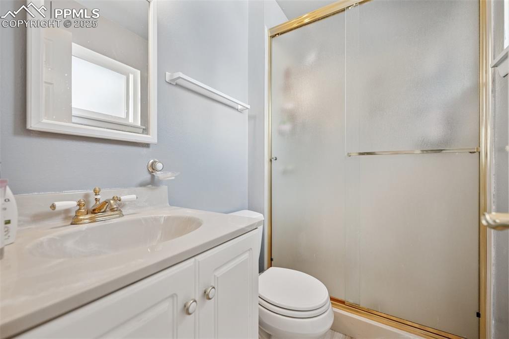 985 Fuller Road Colorado Springs, CO 80920 - Photo 14 of 30 a bathroom with a sink toilet and vanity