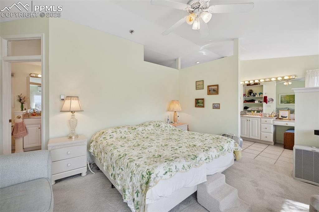 985 Fuller Road Colorado Springs, CO 80920 - Photo 17 of 30 a bedroom with a bed and a chandelier