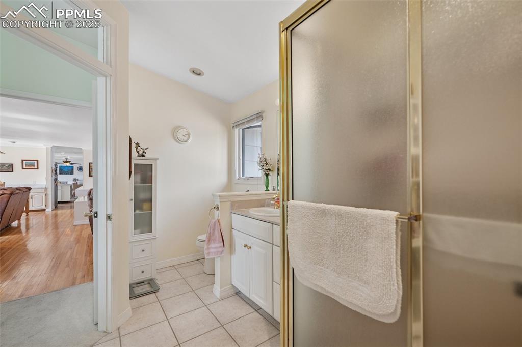 985 Fuller Road Colorado Springs, CO 80920 - Photo 19 of 30 a spacious bathroom with a granite countertop sink a toilet and a mirror