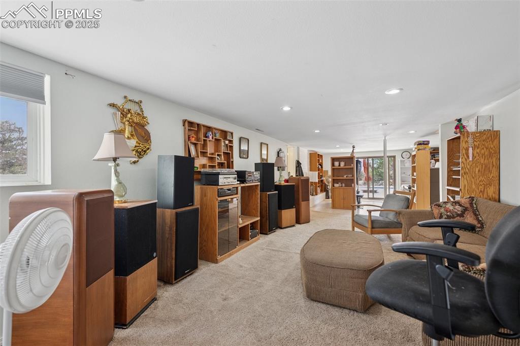985 Fuller Road Colorado Springs, CO 80920 - Photo 22 of 30 a living room with furniture a flat screen tv and large window