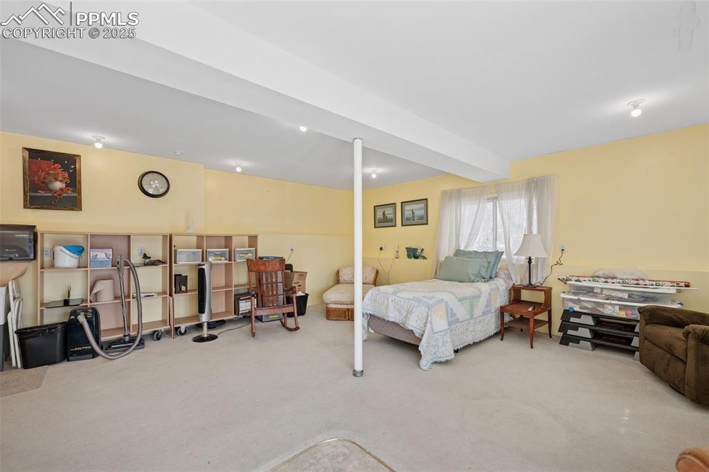 985 Fuller Road Colorado Springs, CO 80920 - Photo 25 of 30 a bedroom with furniture and a large window