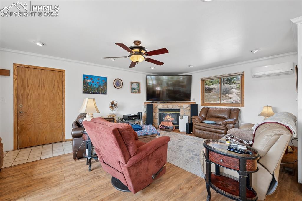 985 Fuller Road Colorado Springs, CO 80920 - Photo 5 of 30 a living room with furniture a ceiling fan and a flat screen tv
