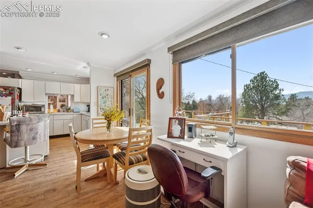 a living room with furniture a flat screen tv and a floor to ceiling window