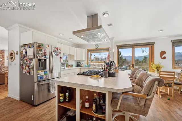 a view of a workspace with furniture and a window