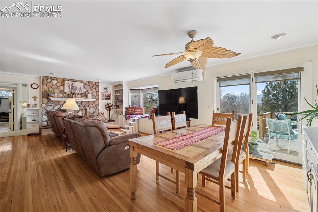985 Fuller Road Colorado Springs, CO 80920 - Photo 10 of 30 a living room with furniture a flat screen tv and a floor to ceiling window