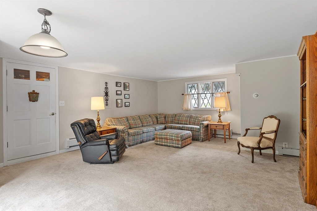 11 Parlee Road Chelmsford, MA 01824 - Photo 13 of 33 a living room with furniture and a chandelier