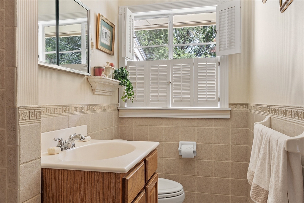 11 Parlee Road Chelmsford, MA 01824 - Photo 19 of 33 a bathroom with a sink a toilet and a mirror