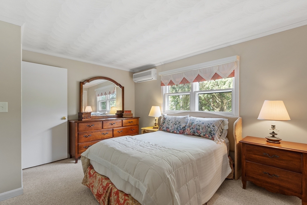 11 Parlee Road Chelmsford, MA 01824 - Photo 20 of 33 a bedroom with a bed and a dresser next to a window