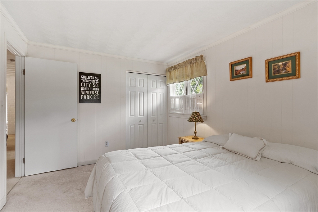 11 Parlee Road Chelmsford, MA 01824 - Photo 27 of 33 a bedroom with a large bed and a chandelier