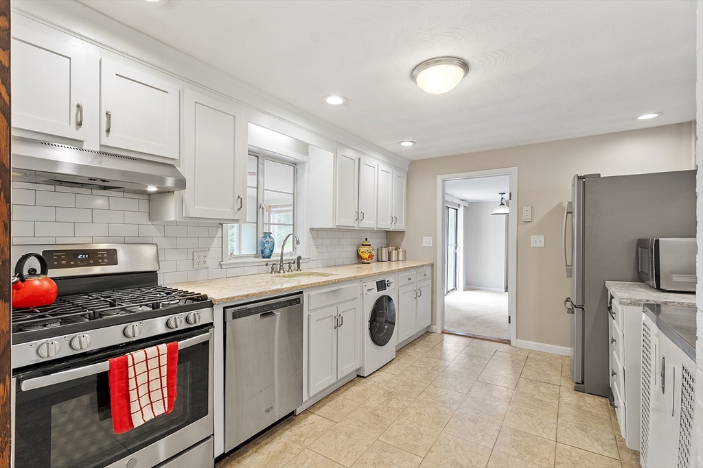 11 Parlee Road Chelmsford, MA 01824 - Photo 6 of 33 a kitchen with stainless steel appliances granite countertop a stove and a sink
