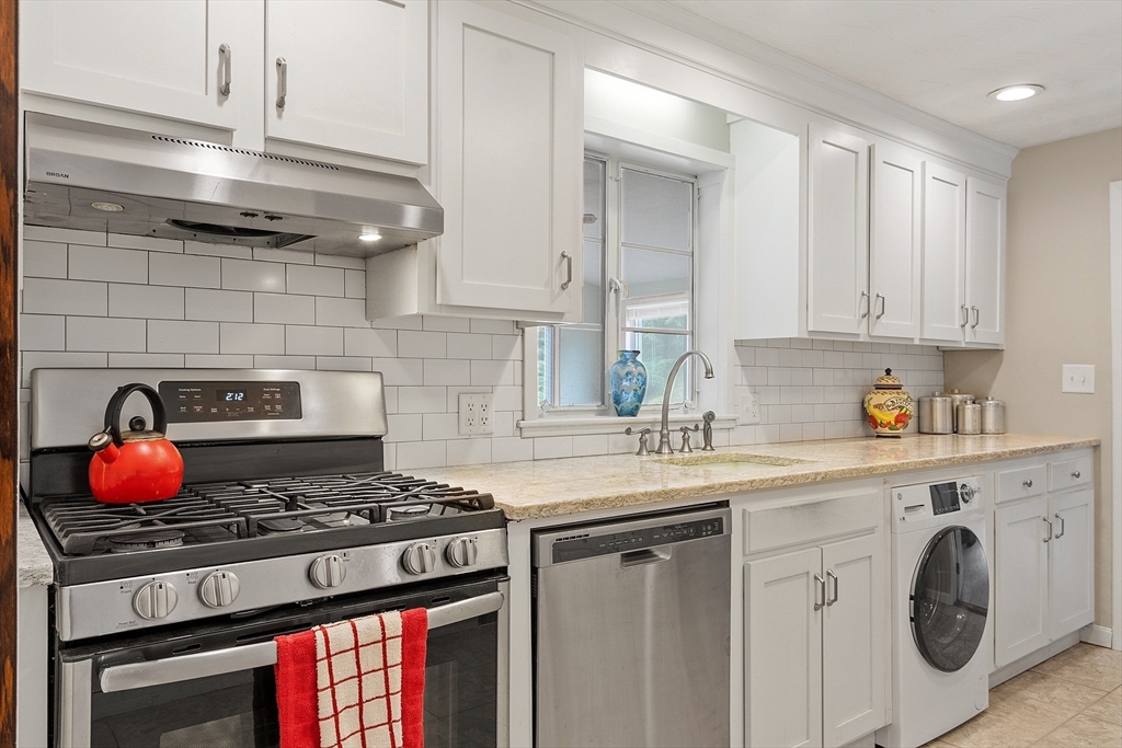 11 Parlee Road Chelmsford, MA 01824 - Photo 7 of 33 a kitchen with stainless steel appliances granite countertop stove top oven and cabinets