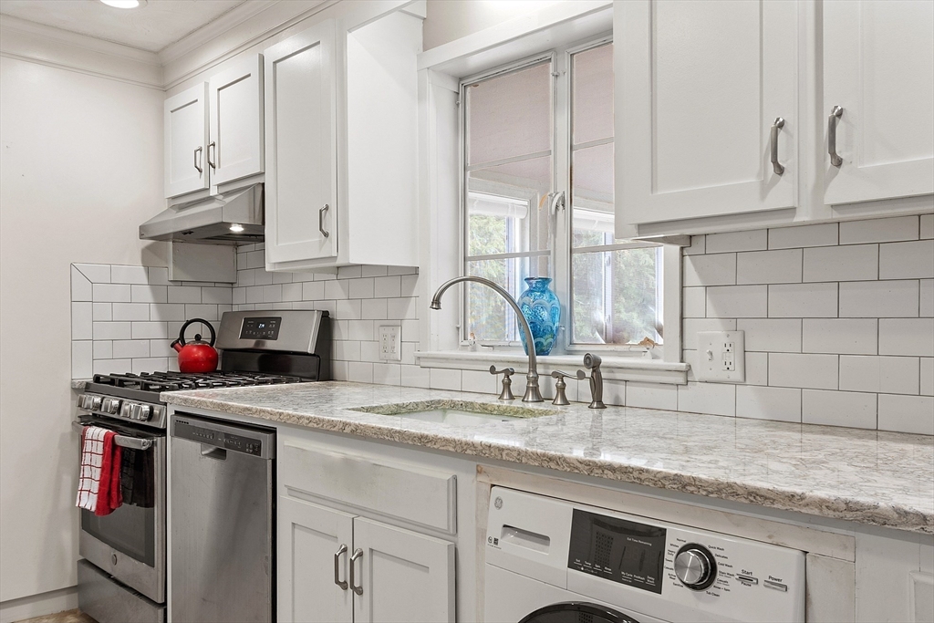 11 Parlee Road Chelmsford, MA 01824 - Photo 8 of 33 a kitchen with stainless steel appliances granite countertop a sink stove and cabinets