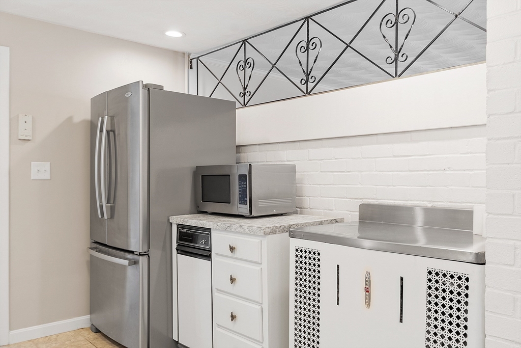 11 Parlee Road Chelmsford, MA 01824 - Photo 9 of 33 a kitchen with stainless steel appliances a refrigerator and cabinets
