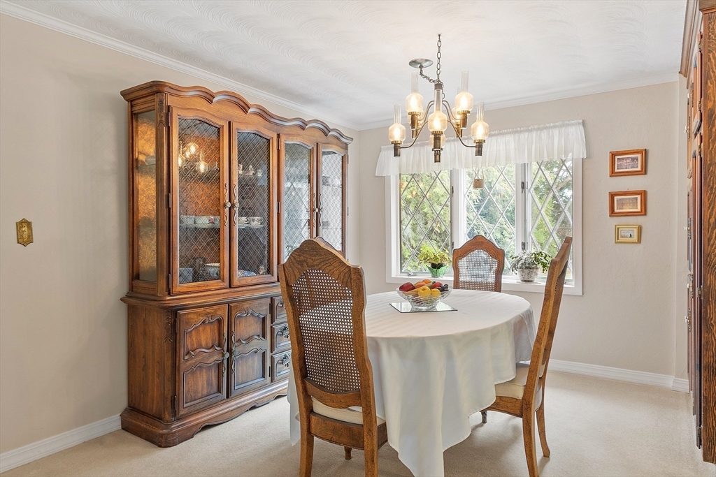 11 Parlee Road Chelmsford, MA 01824 - Photo 10 of 33 a dining room with furniture a chandelier and wooden floor