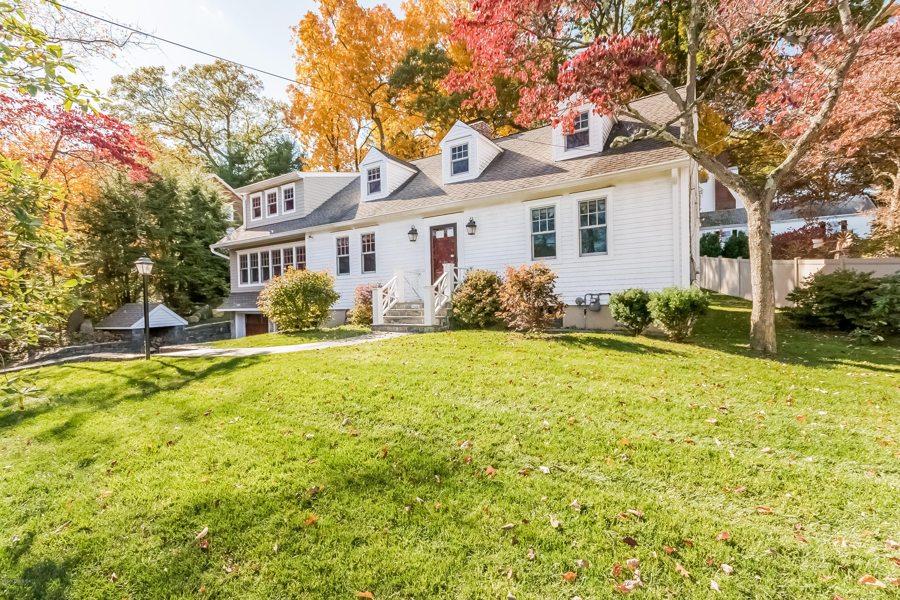 355 Riverside Avenue Riverside, CT 06878 - Photo 17 of 24 a front view of house with yard and trees around