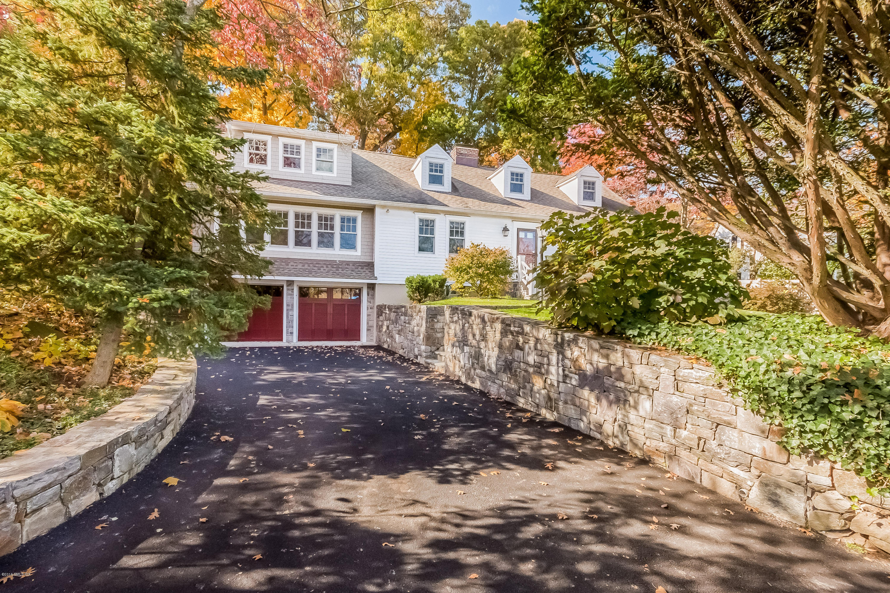 355 Riverside Avenue Riverside, CT 06878 - Photo 2 of 24 a front view of a house with a yard and potted plants