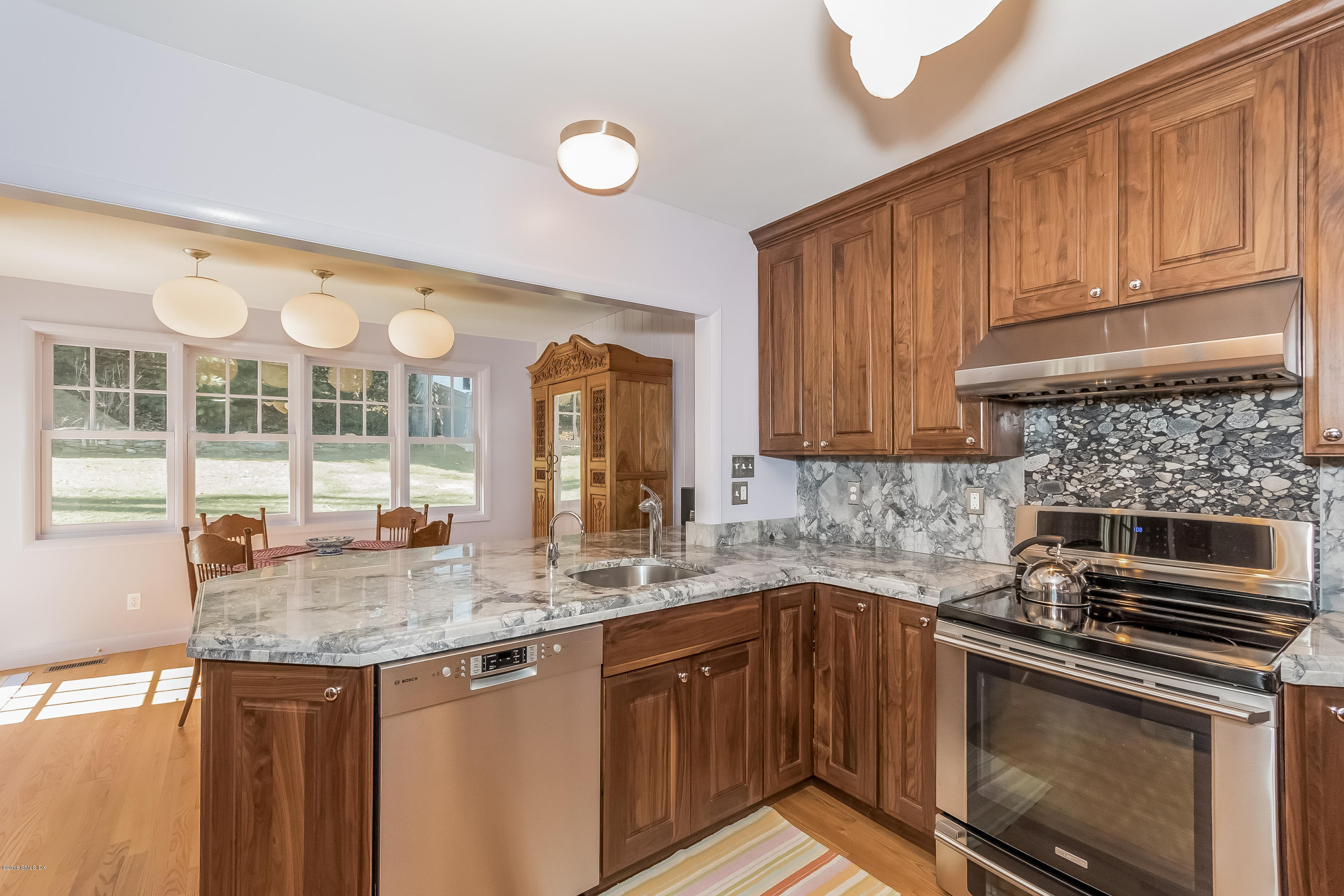 355 Riverside Avenue Riverside, CT 06878 - Photo 3 of 24 a kitchen with granite countertop a stove sink and cabinets