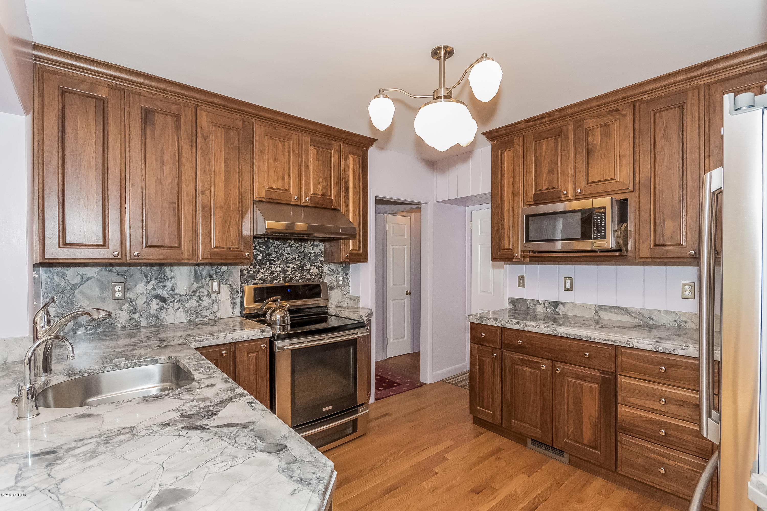 355 Riverside Avenue Riverside, CT 06878 - Photo 4 of 24 a kitchen with granite countertop wooden cabinets stainless steel appliances and a sink
