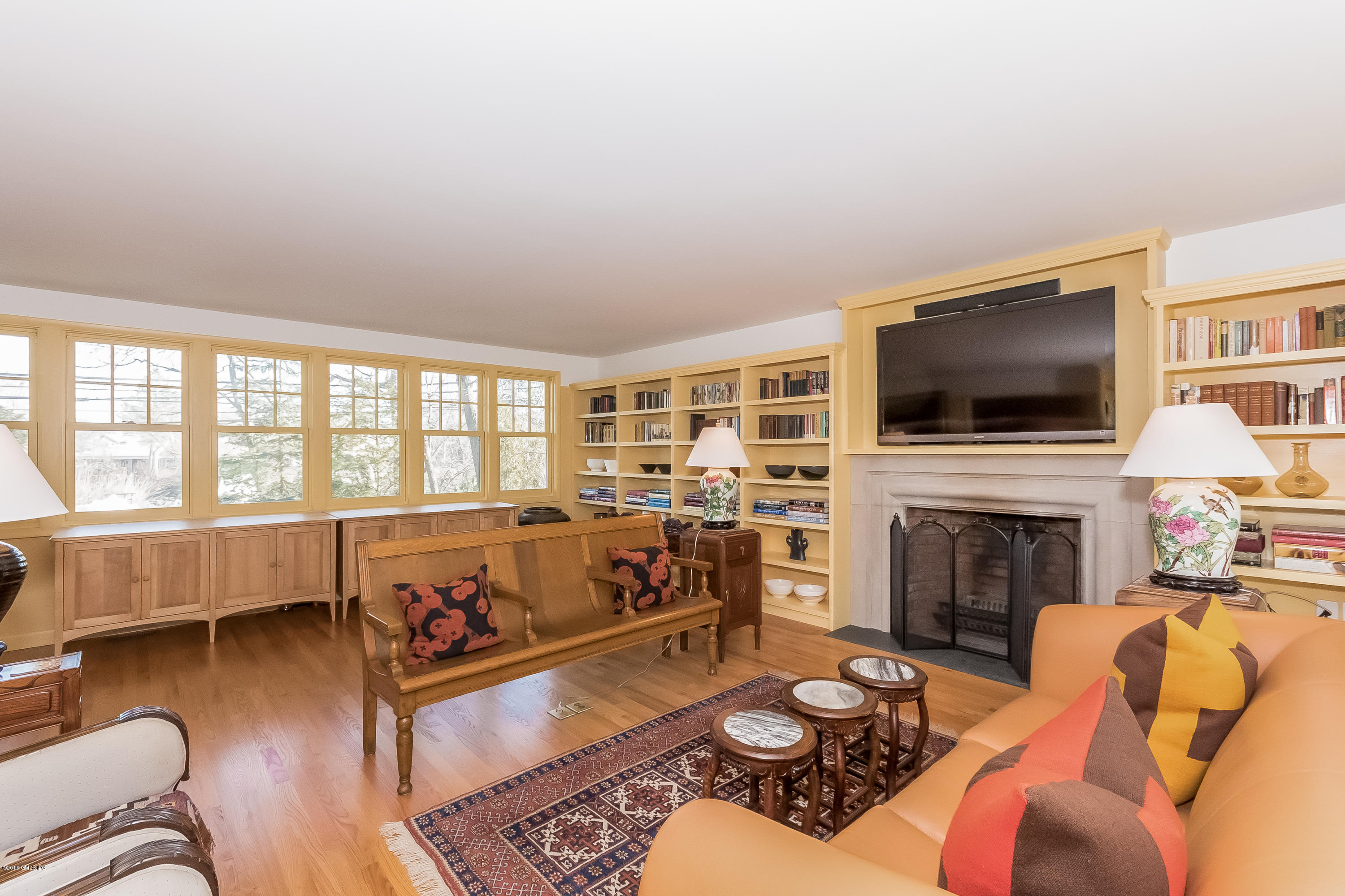 355 Riverside Avenue Riverside, CT 06878 - Photo 9 of 24 a living room with furniture a fireplace and a flat screen tv
