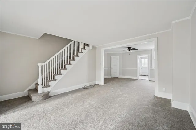 a view of an empty room with stairs
