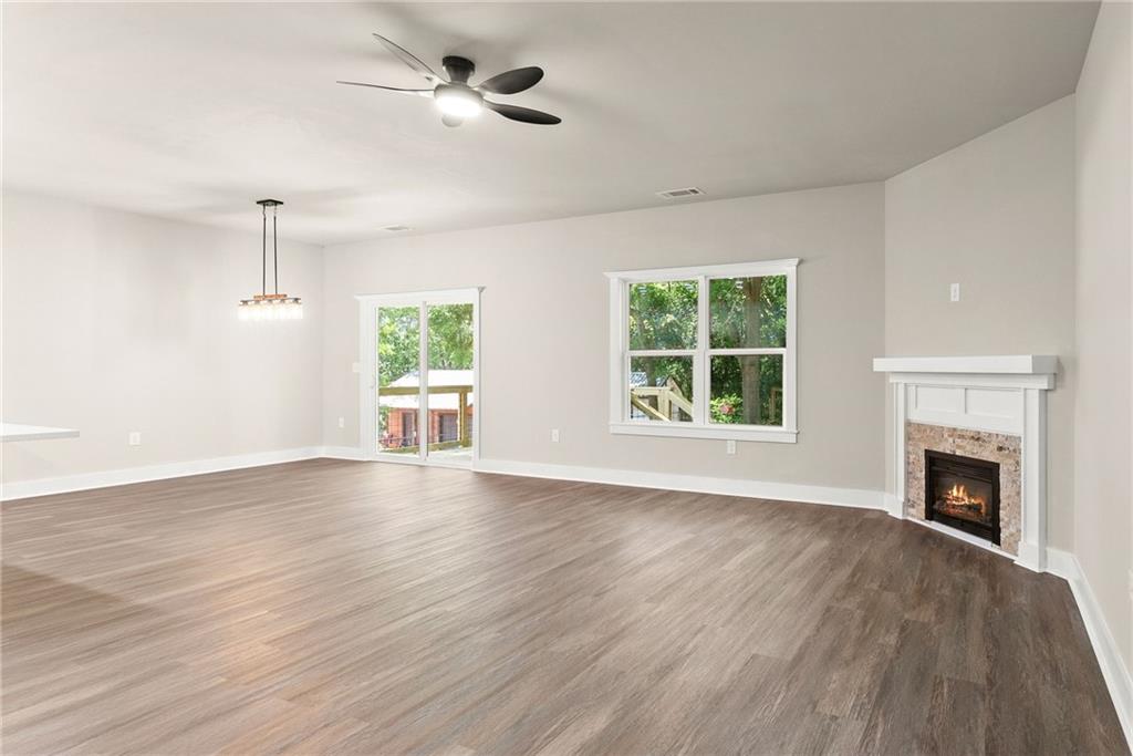 43 Anderson Street Jefferson, GA 30549 - Photo 15 of 45 a view of an empty room with wooden floor fireplace and a window