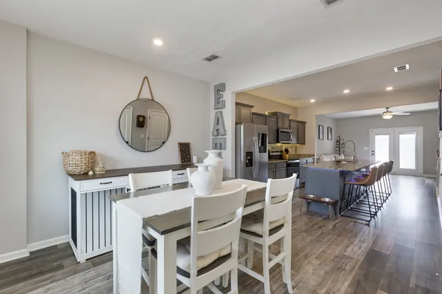 a view of a dining room with furniture and wooden floor