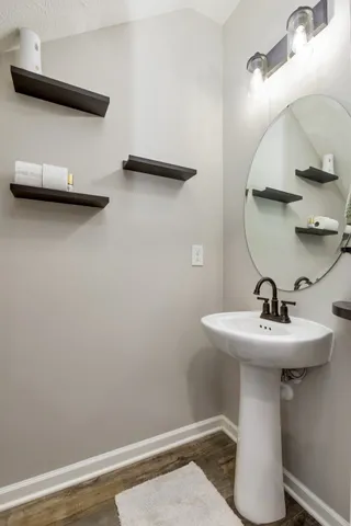 a bathroom with a sink a mirror and shower