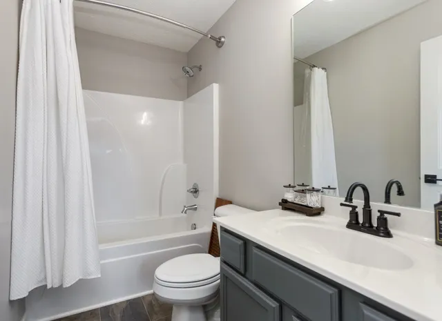 a bathroom with a sink a toilet and a bathtub