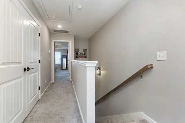 a view of a hallway with closet and utility room