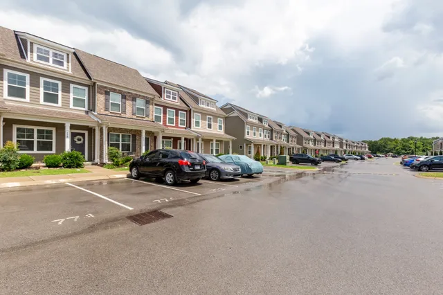 a couple of cars parked in front of a building