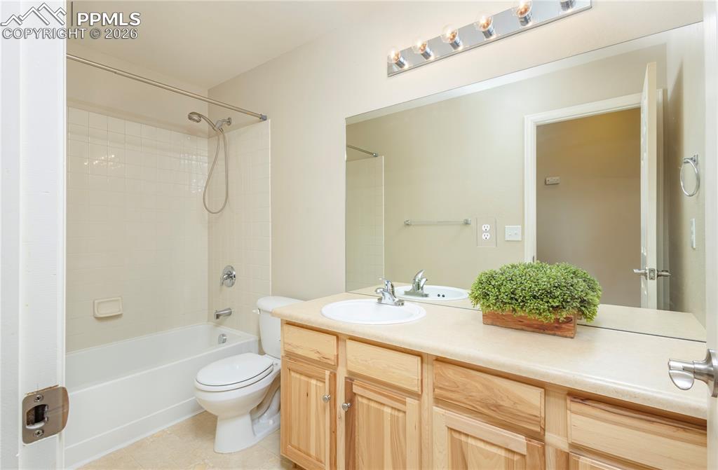 4815 Harrier Ridge Drive Colorado Springs, CO 80916 - Photo 16 of 33 Bathroom with vanity, washtub / shower combination, and light tile patterned floors