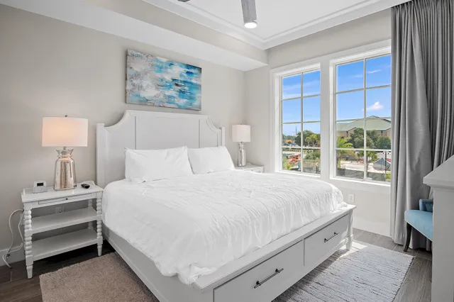 a bedroom with a bed and a large window