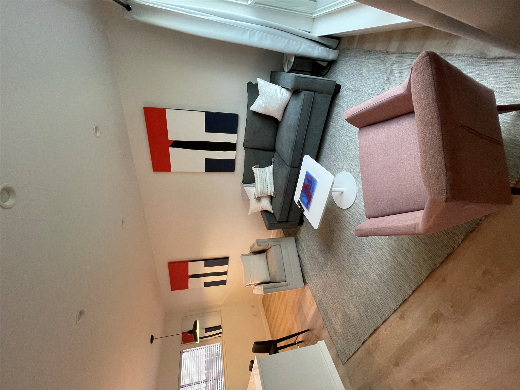 1714 Enfield Road, Unit 102 Austin, TX 78703 - Photo 2 of 15 Bright hardwood floors complement a neutral rug in this inviting living space.