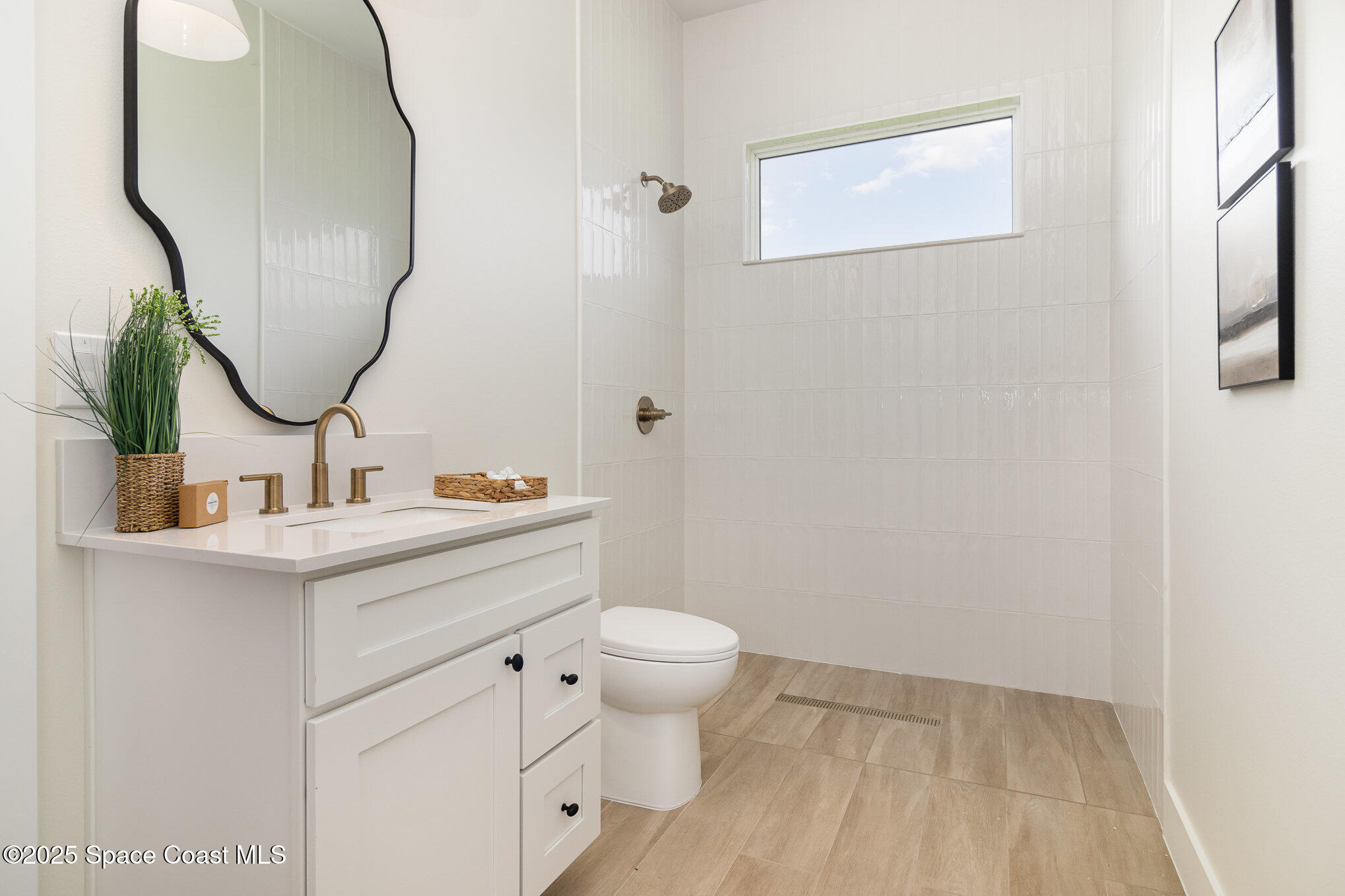 508 Topsail Drive Rockledge, FL 32955 - Photo 25 of 41 a bathroom with a sink a toilet and a mirror