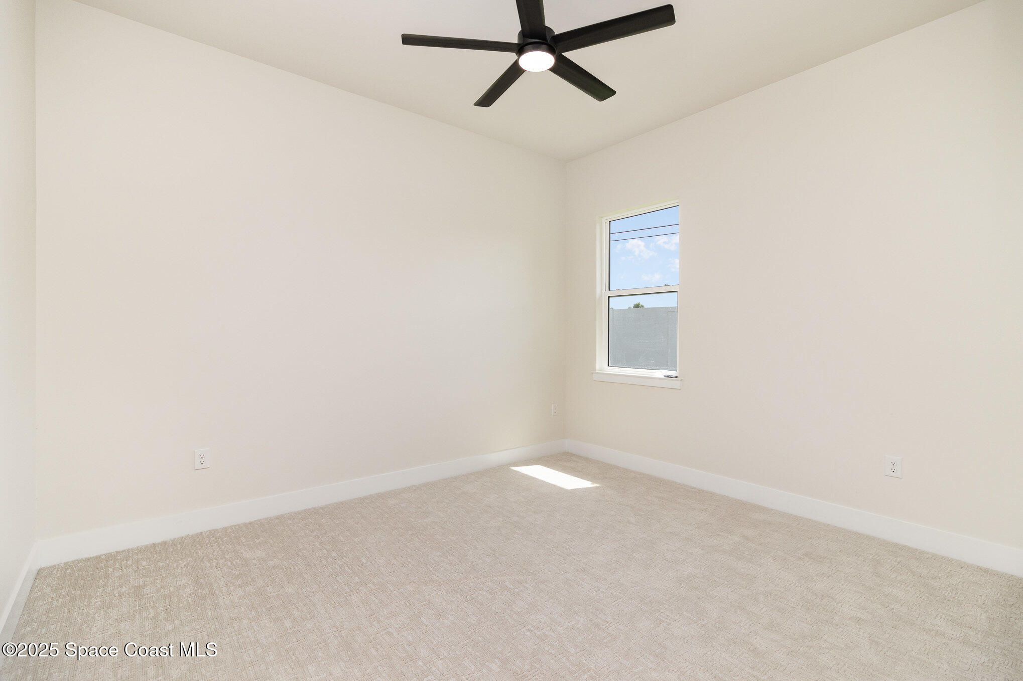 508 Topsail Drive Rockledge, FL 32955 - Photo 33 of 41 an empty room with a window and a ceiling fan