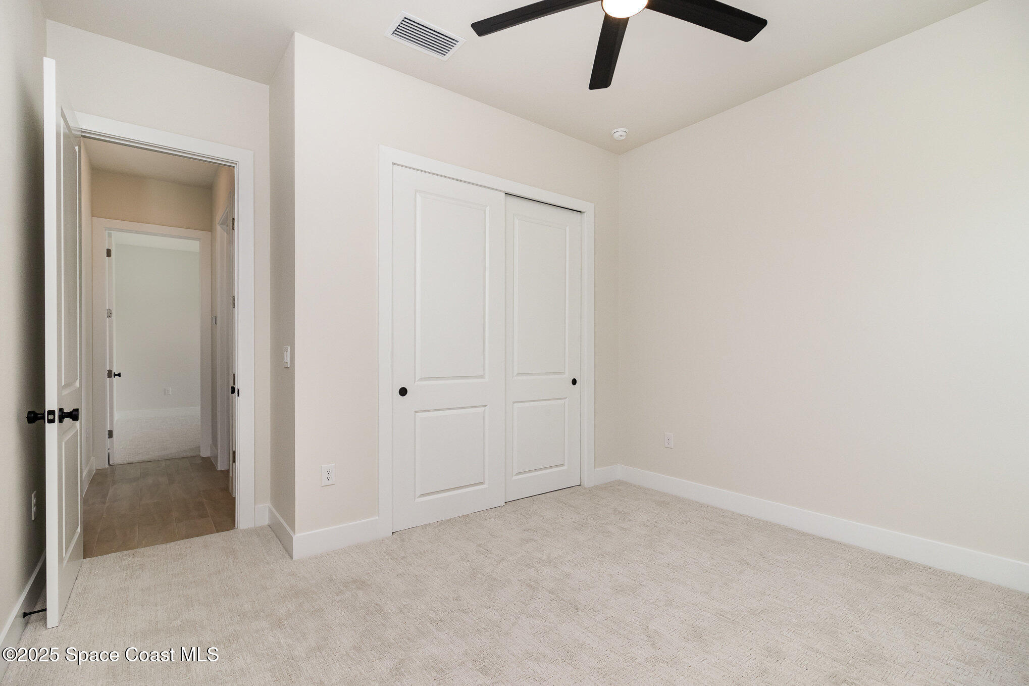 508 Topsail Drive Rockledge, FL 32955 - Photo 35 of 41 an empty room with a ceiling fan and carpet