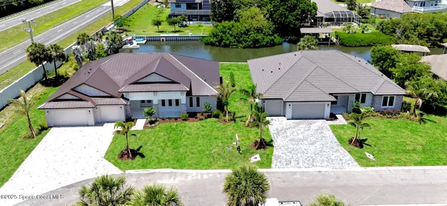 a aerial view of a house with a yard and potted plants