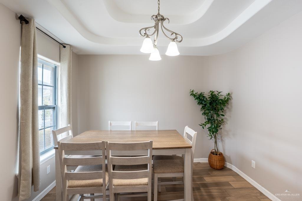 5108 South 33rd Street McAllen, TX 78503 - Photo 4 of 17 a view of a dining room with furniture and chandelier