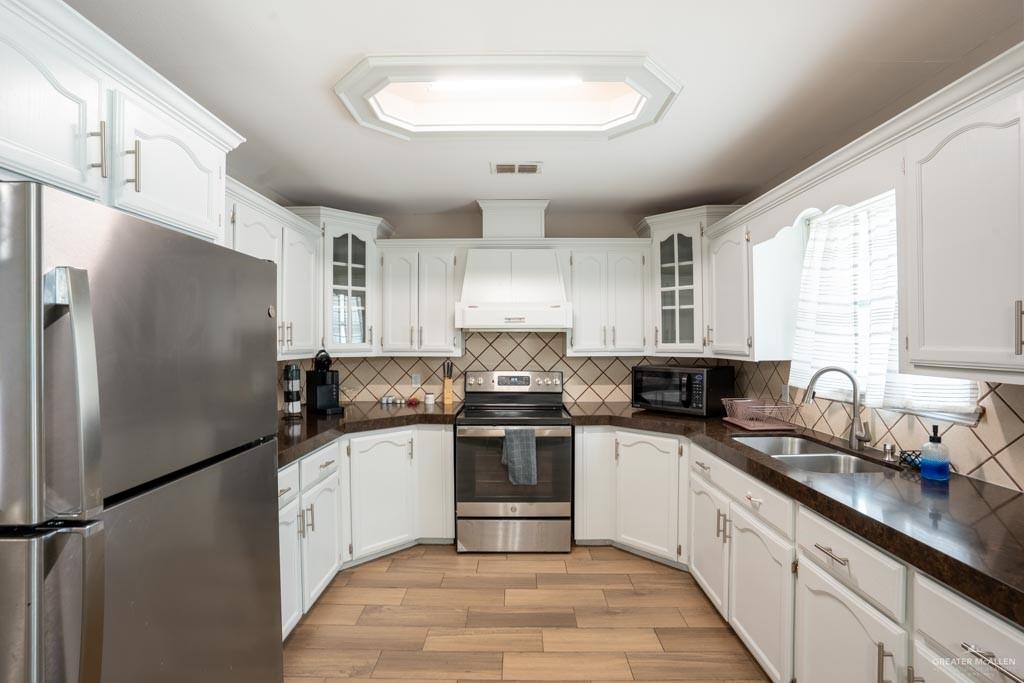 5108 South 33rd Street McAllen, TX 78503 - Photo 5 of 17 a kitchen with stainless steel appliances granite countertop a sink stove and refrigerator