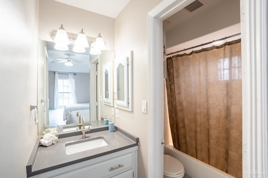 5108 South 33rd Street McAllen, TX 78503 - Photo 8 of 17 a bathroom with a sink vanity mirror and toilet
